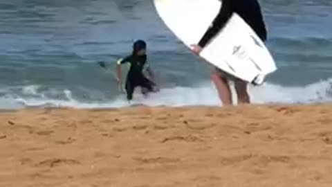 Guy attempts to head out to surf with huge waves approaching