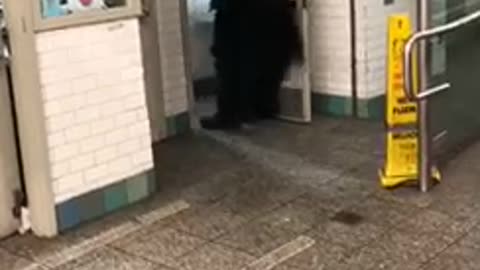 Man in batman costume walks out of restroom