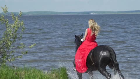 Girls on horseback along the shore