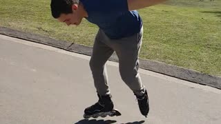 Blue shirt guy on roller skates falls down on concrete