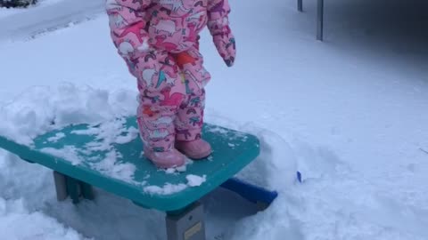 Toddler Face Plants into Snow off Picnic Table