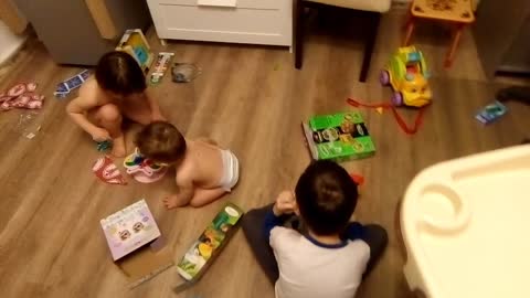 Children open Christmas gifts.