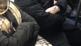 Man red beanie shaving on the train