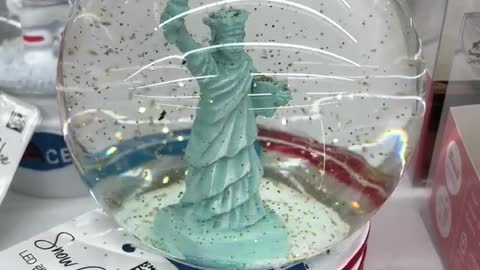 a glass ball containing the Statue of Liberty