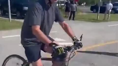 Biden falls off his bike after trying to dismount