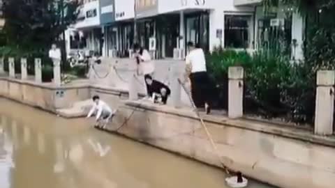 Two Men Rescue A Stranded Cat From Under A Bridge