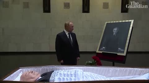 Vladimir Putin lays flowers next to open coffin of Mikhail Gorbachev
