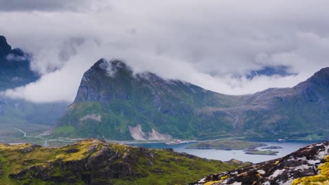 the volandstinden mountaintop on the lofoten islands norway on a cloudy summer day