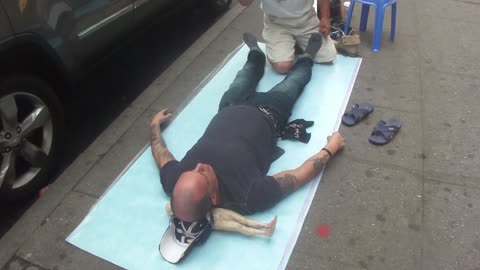 Luodong Massages Skinny Tattooed White Man On Sidewalk