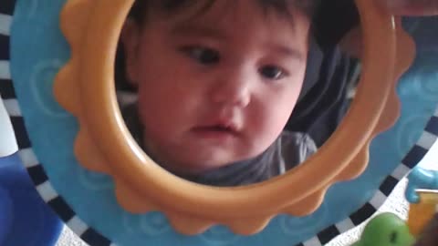 Baby cracks up after discovering his reflection