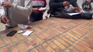 Brownsville, TX: Migrants open their DHS packets and use their government issued cell phones