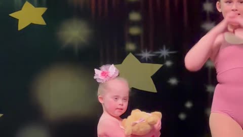 Daughter With Down Syndrome And Her Big Sister At Ballet Recital