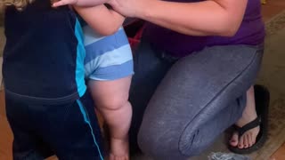 Toddler Tries to Hold Big Cousin Infant