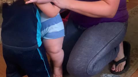Toddler Tries to Hold Big Cousin Infant