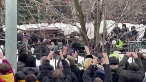 Alexei Navalny’s body seen in coffin as thousands defy Putin to honor opposition leader