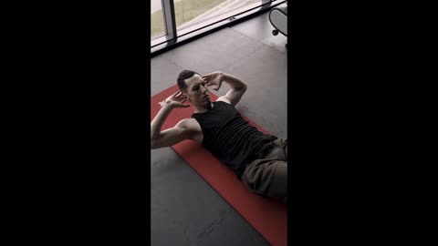 A Man Doing Abdominal Exercises On The Gym Floor