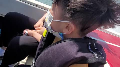 A family that enjoys the thrill of a boat ride.