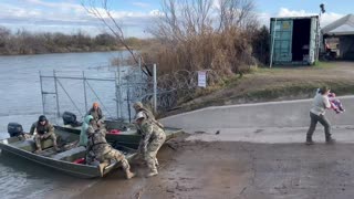 Texas National Guard rescuing a woman and her child from the Rio Grande