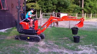 Jims Excavator #4 Seven year old Daniel moving water buckets with the Kubota K008-3 excavator.