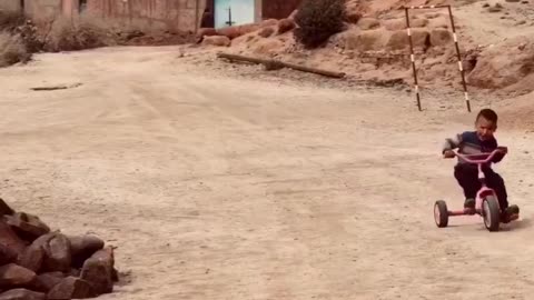 A Moroccan kid is excited to ride his bike with a great song