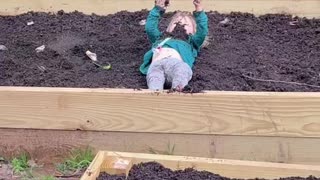 Toddler Plays in Garden Dirt