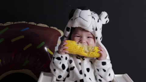 Baby eating sweetcorn for the first time...