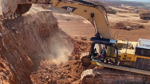 Caterpillar 365C Excavator Loading Trucks