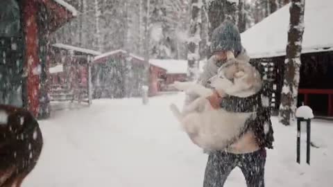 A Couple and Dog Playing with Snow