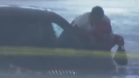 Reporter rescues nurse from severe floodwaters as she tries to drive to work