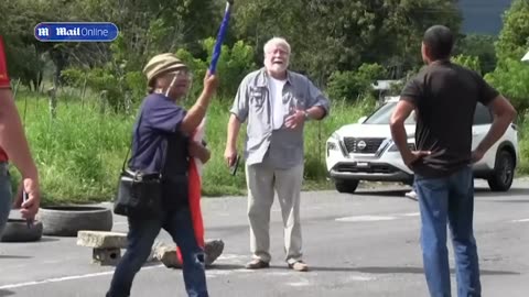 Shocking moment motorist shoots dead two environmental protesters blocking a road