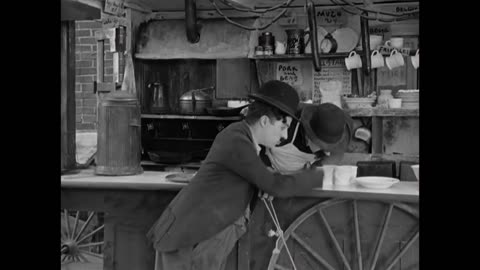 Charlie Chaplin and his brother Sydney in a scene from A Dog