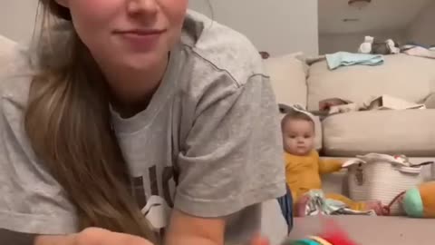 Baby Crawls Over to Mom for Toy and Phone |