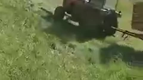 Tractor Trying to Drive Uphill Slides Backwards and falls Into Water
