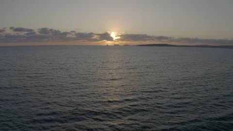 flying-over-the-sea-during-sunset-medium