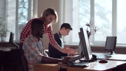 Students helping each other in the computer room