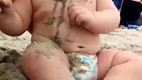 Funny baby reaction on beach