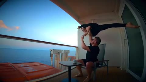 Circus Performers Sip Coffee on Cruise Ship as Man Balances Woman Doing Split on His Hand