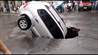 Car Sinks Into Major Pothole