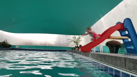 Lana sliding/diving into pool