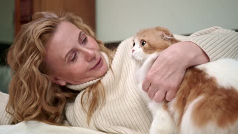 Cat and women play on bedroom