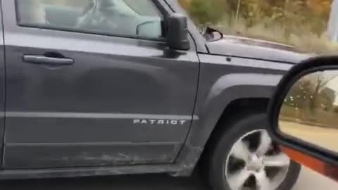 Woman driving her Jeep Patriot without a tire