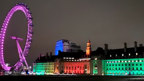 colorful-lights-in-a-building-behind-a-ferris-whee