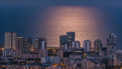 view of barcelona skyline timelapse with moonpath from full rising moon the mediterranean