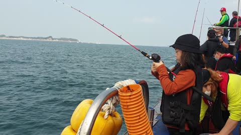 My daughter, octopus fishing on board.