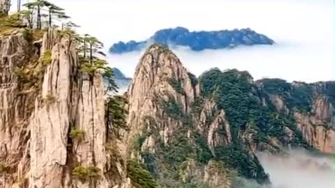 A beautiful view of mountains and white clouds