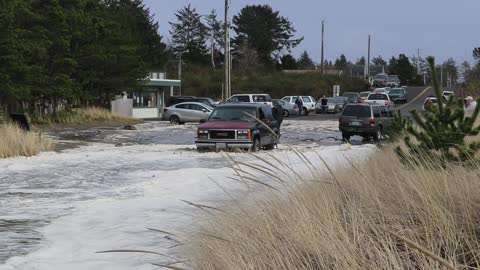 Storm Surge Leaves Car Stranded on Sand Dune