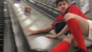 Guy Falls From An Escalator