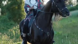 Beautiful girl with her black horse
