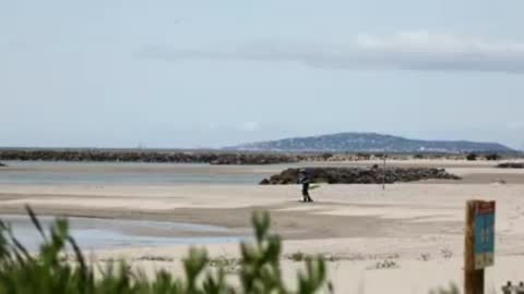 Cop Arrests Blow Up Doll Lying On Beach Under Parasol