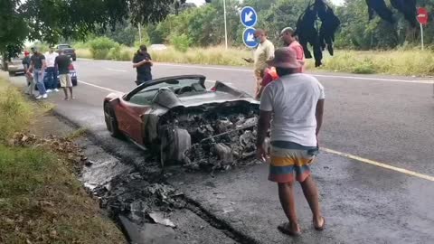 A red Ferarri goes up in flames on the M4